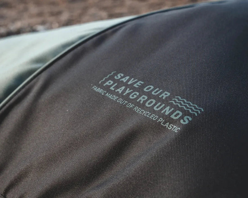 Text on a black fabric surface with 'Save Our Playgrounds' branding. kiteboard bag front photo